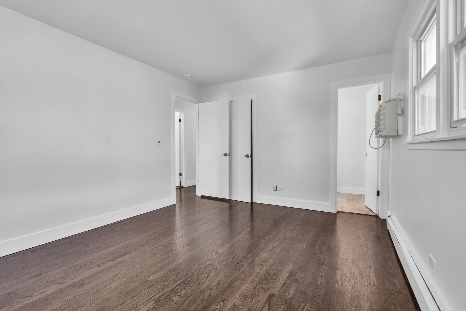 512 Ida Court, Unit 1 Mount Prospect, IL 60056 - Photo 12 of 22 a view of an empty room with wooden floor