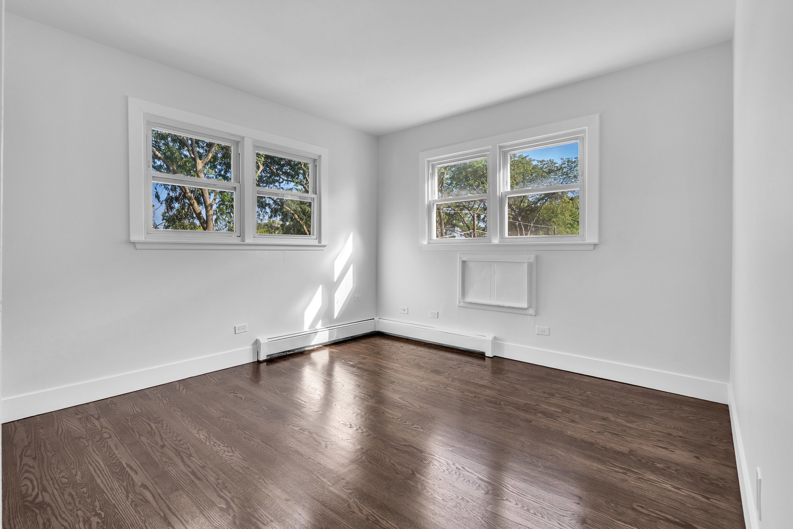 512 Ida Court, Unit 1 Mount Prospect, IL 60056 - Photo 14 of 22 a view of an empty room with wooden floor and a window