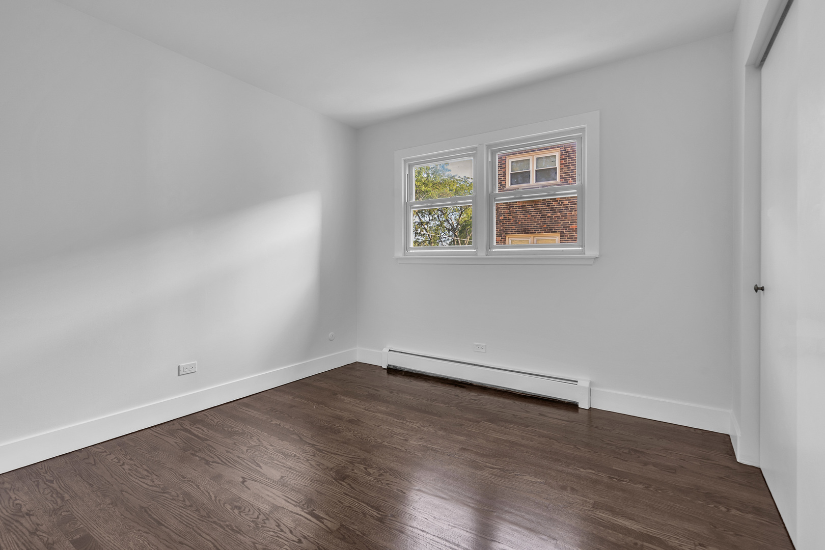 512 Ida Court, Unit 1 Mount Prospect, IL 60056 - Photo 16 of 22 wooden floor in an empty room with a window