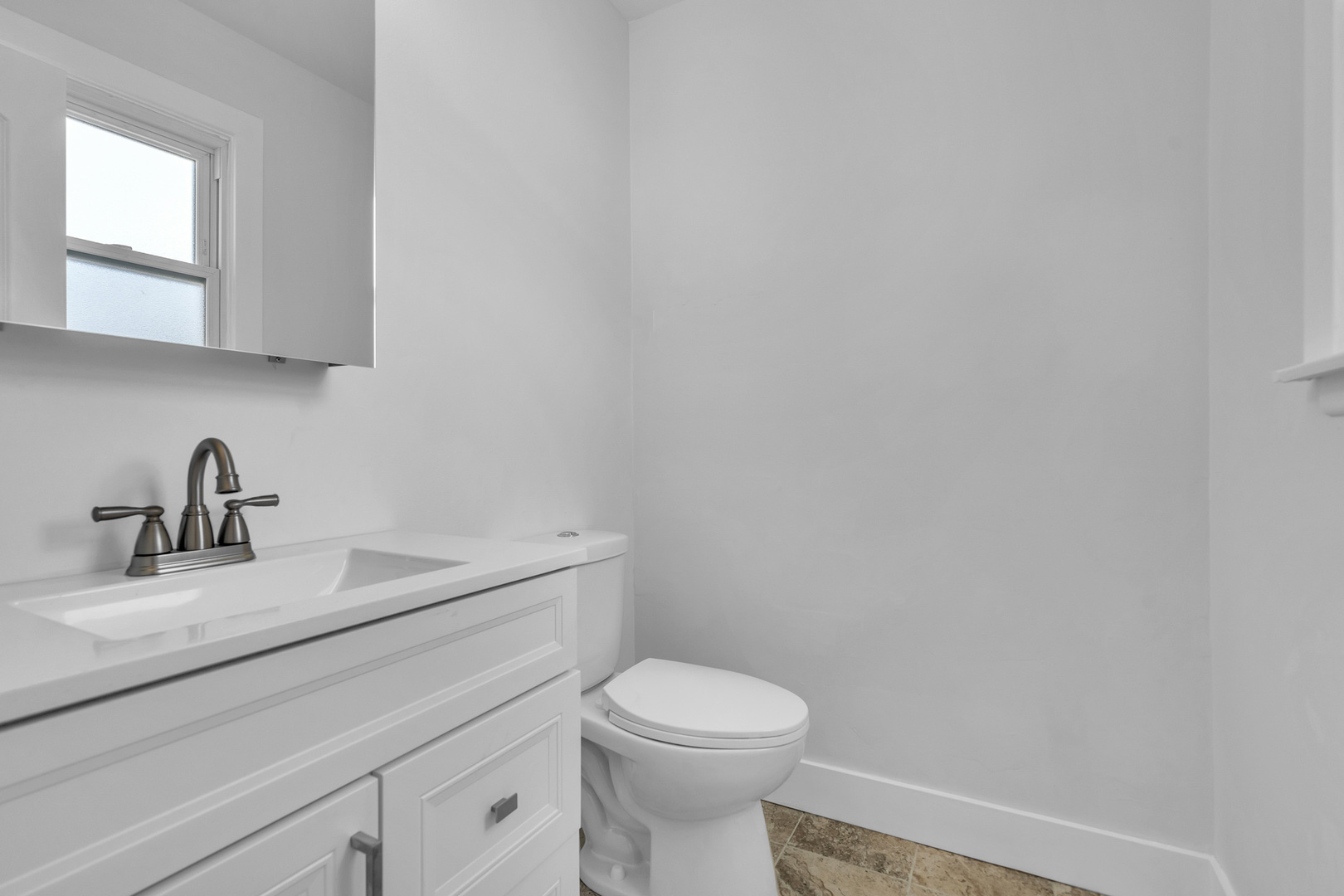 512 Ida Court, Unit 1 Mount Prospect, IL 60056 - Photo 18 of 22 a bathroom with a toilet sink vanity and mirror