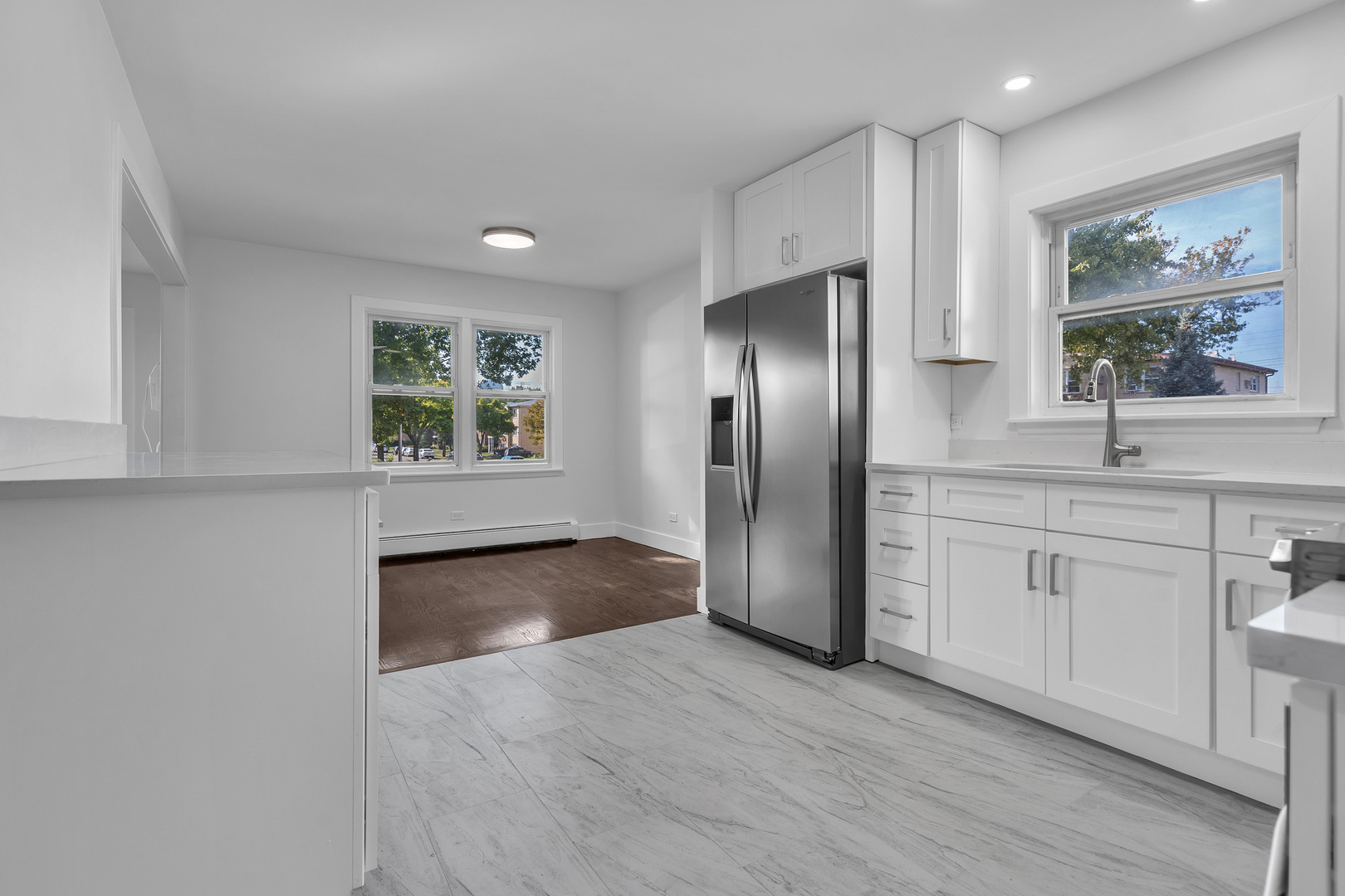 512 Ida Court, Unit 1 Mount Prospect, IL 60056 - Photo 5 of 22 a kitchen with stainless steel appliances granite countertop a refrigerator and a sink