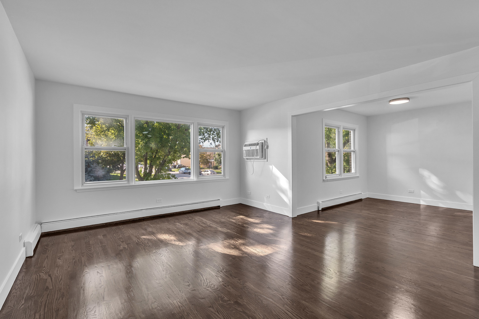 512 Ida Court, Unit 1 Mount Prospect, IL 60056 - Photo 8 of 22 an empty room with wooden floor and windows