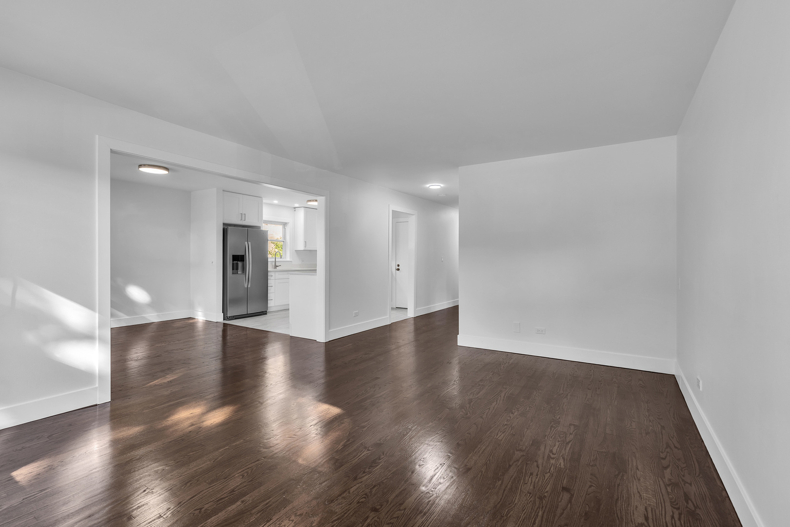 512 Ida Court, Unit 1 Mount Prospect, IL 60056 - Photo 9 of 22 a view of an empty room with wooden floor and a window
