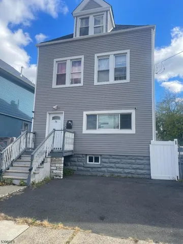 a front view of a house with stairs