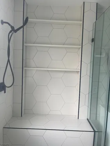 a bathroom with a glass shower door
