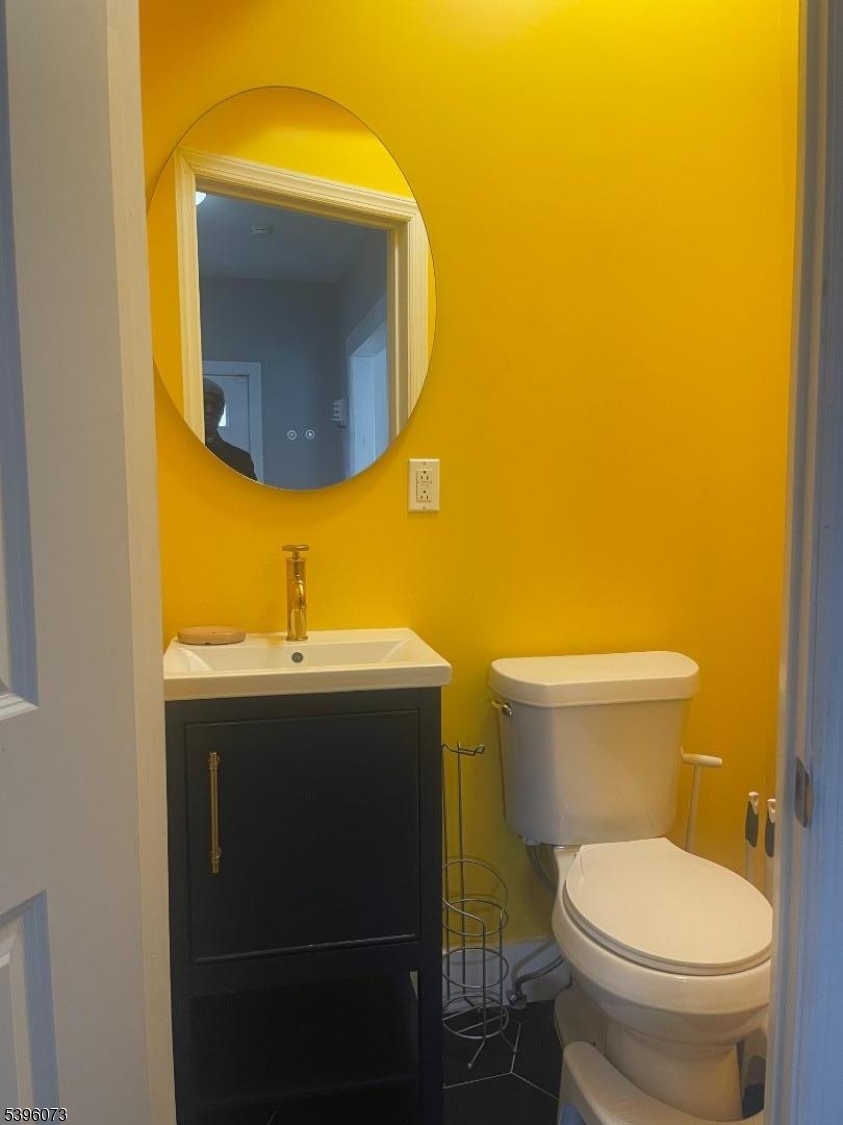 36 Augusta Street Irvington, NJ 07111 - Photo 10 of 15 a bathroom with a sink and a mirror