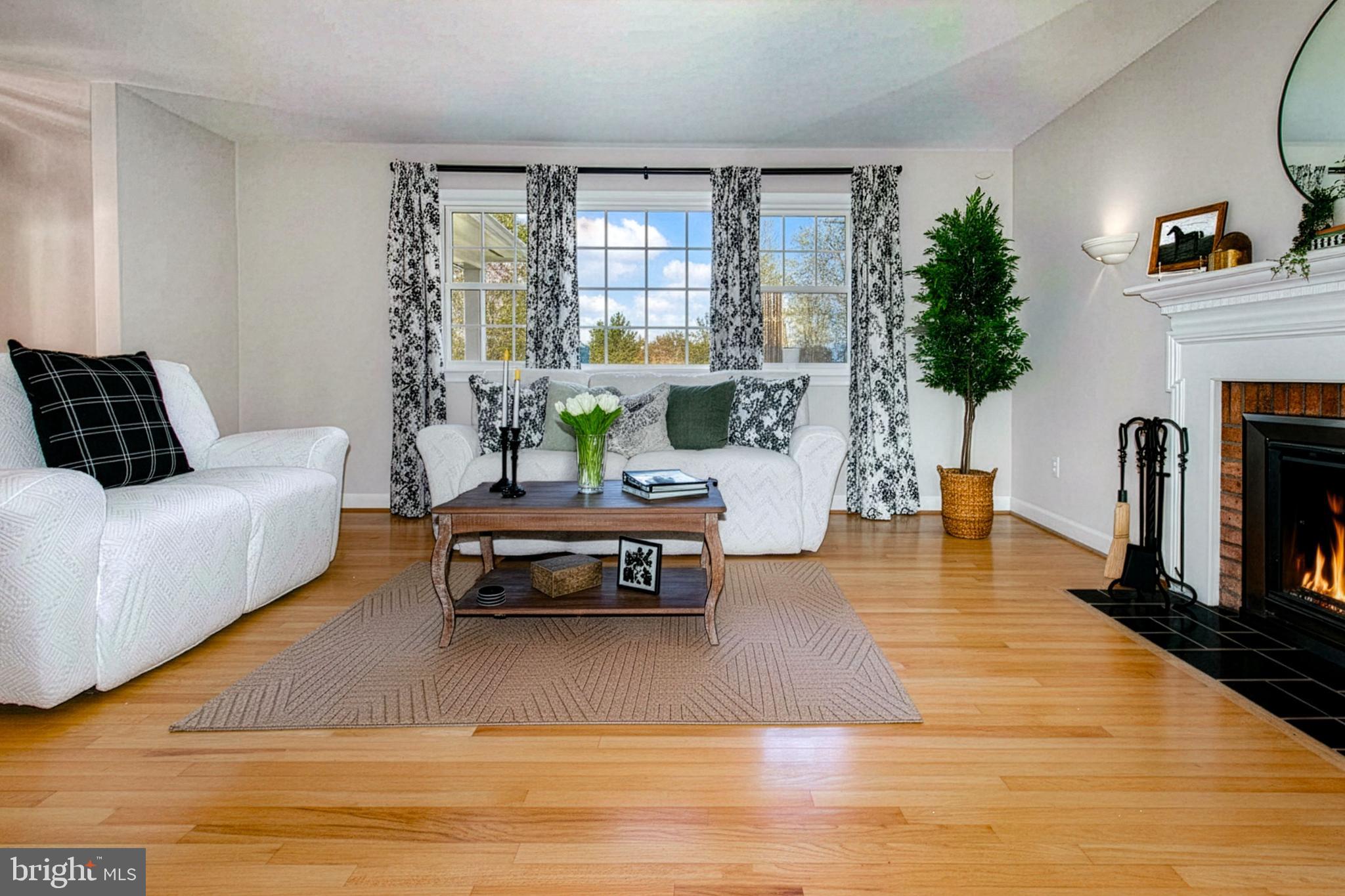 12415 Caisson Road Fairfax, VA 22030 - Photo 14 of 39 a living room with furniture a large window and a fireplace