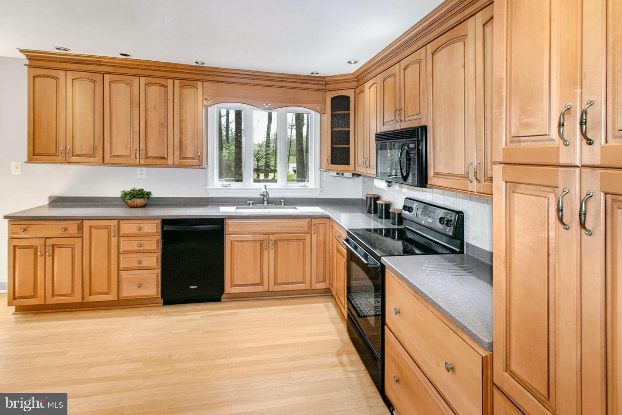 12415 Caisson Road Fairfax, VA 22030 - Photo 16 of 39 a kitchen with a sink stove and cabinets