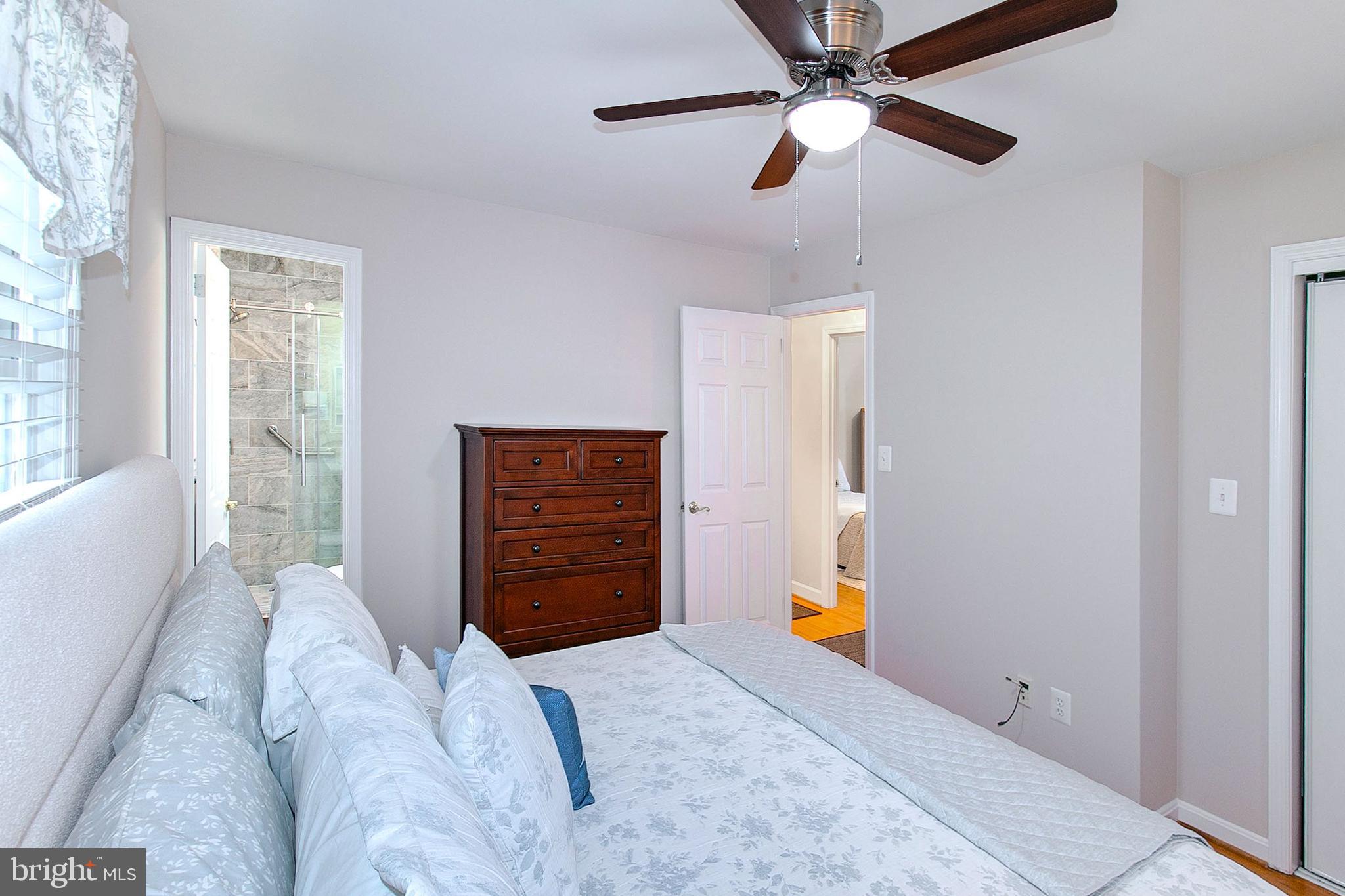 12415 Caisson Road Fairfax, VA 22030 - Photo 20 of 39 a bedroom with a bed and a chandelier
