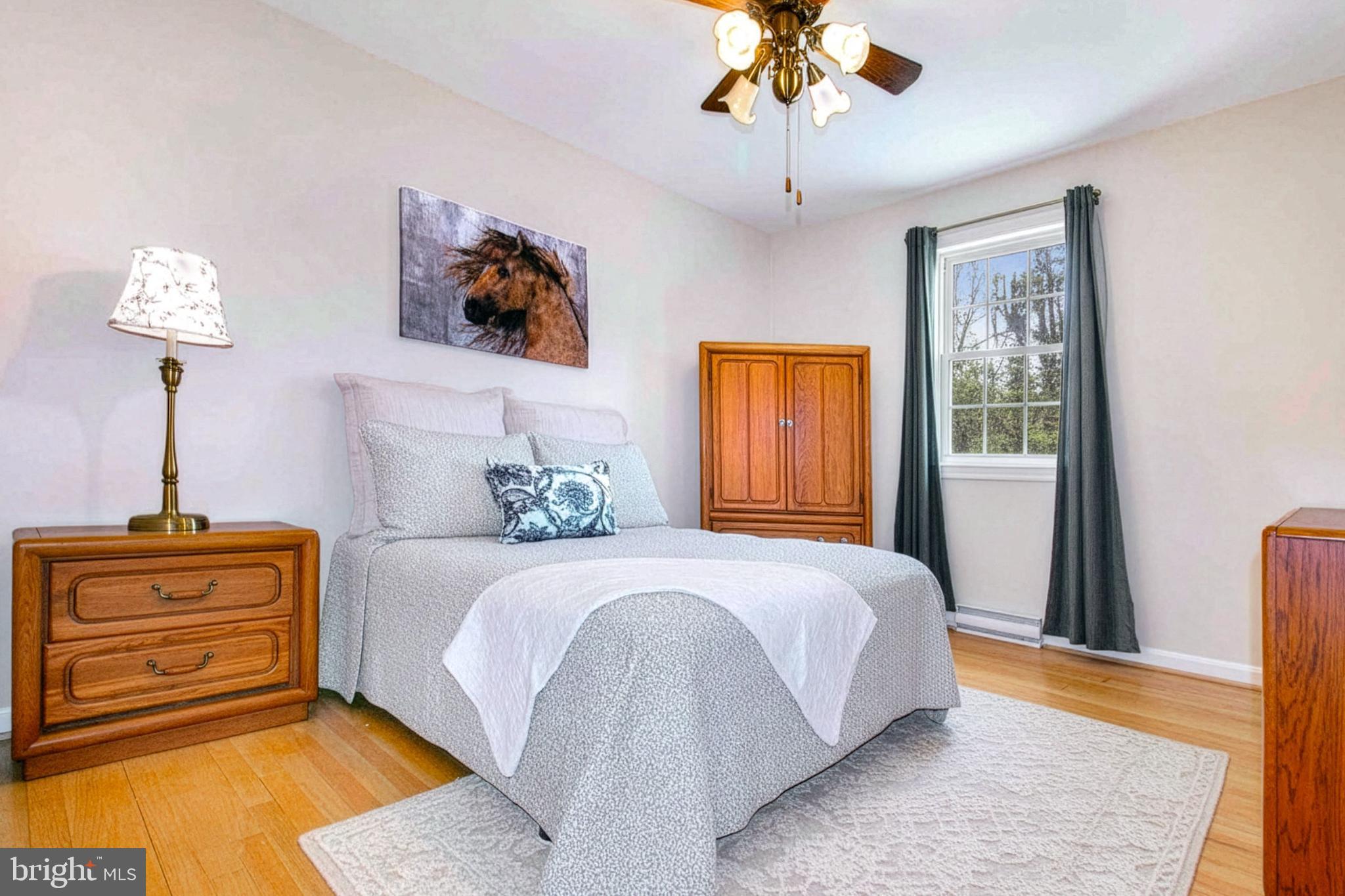 12415 Caisson Road Fairfax, VA 22030 - Photo 23 of 39 a bedroom with a bed and a chandelier