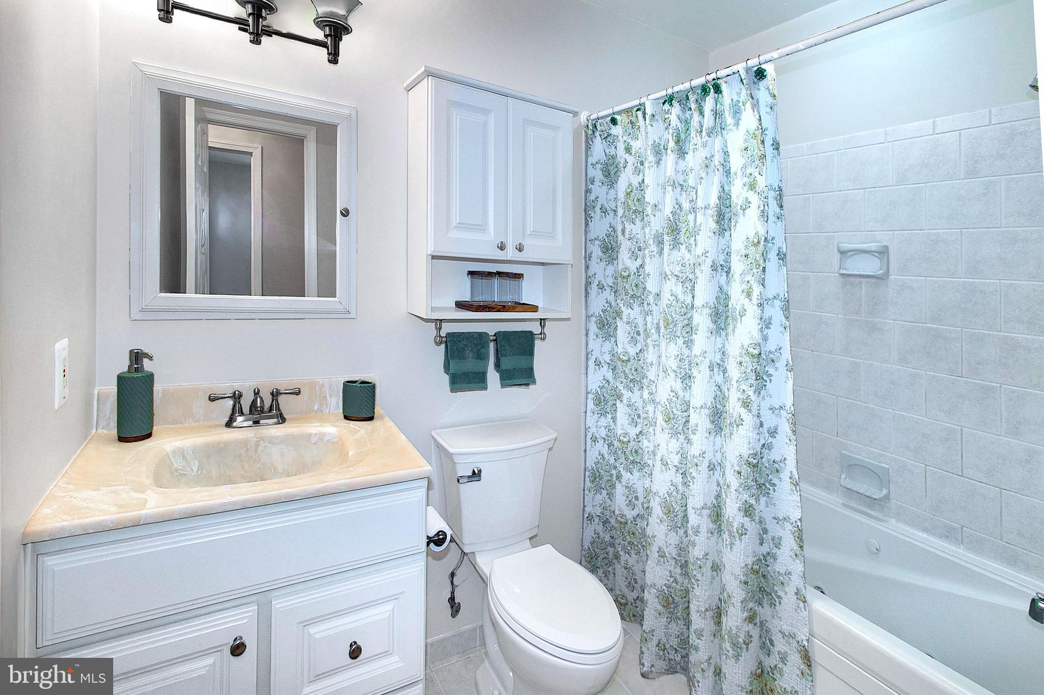 12415 Caisson Road Fairfax, VA 22030 - Photo 25 of 39 a bathroom with a sink a toilet and shower
