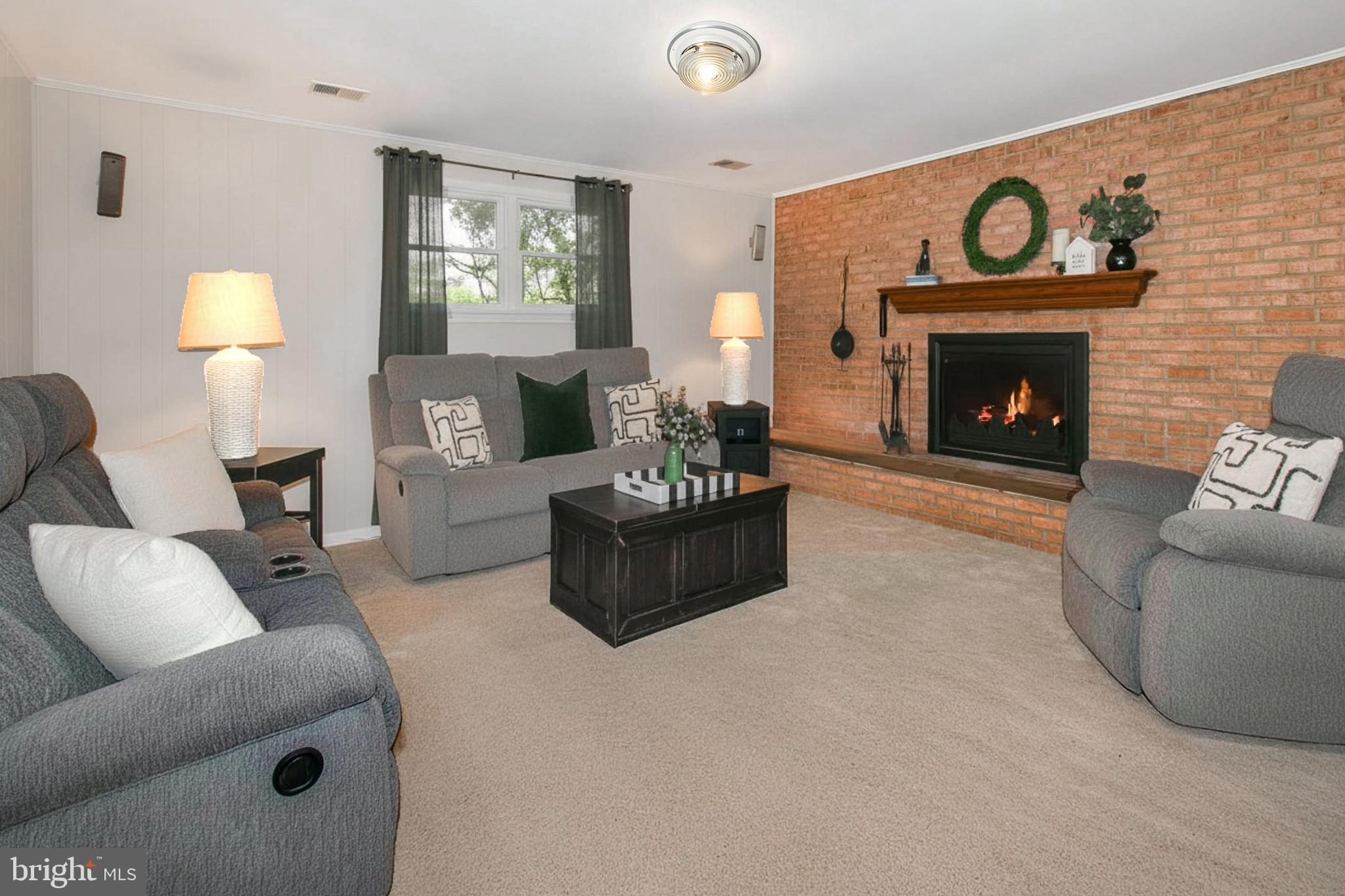 12415 Caisson Road Fairfax, VA 22030 - Photo 26 of 39 a living room with furniture a fireplace and a table