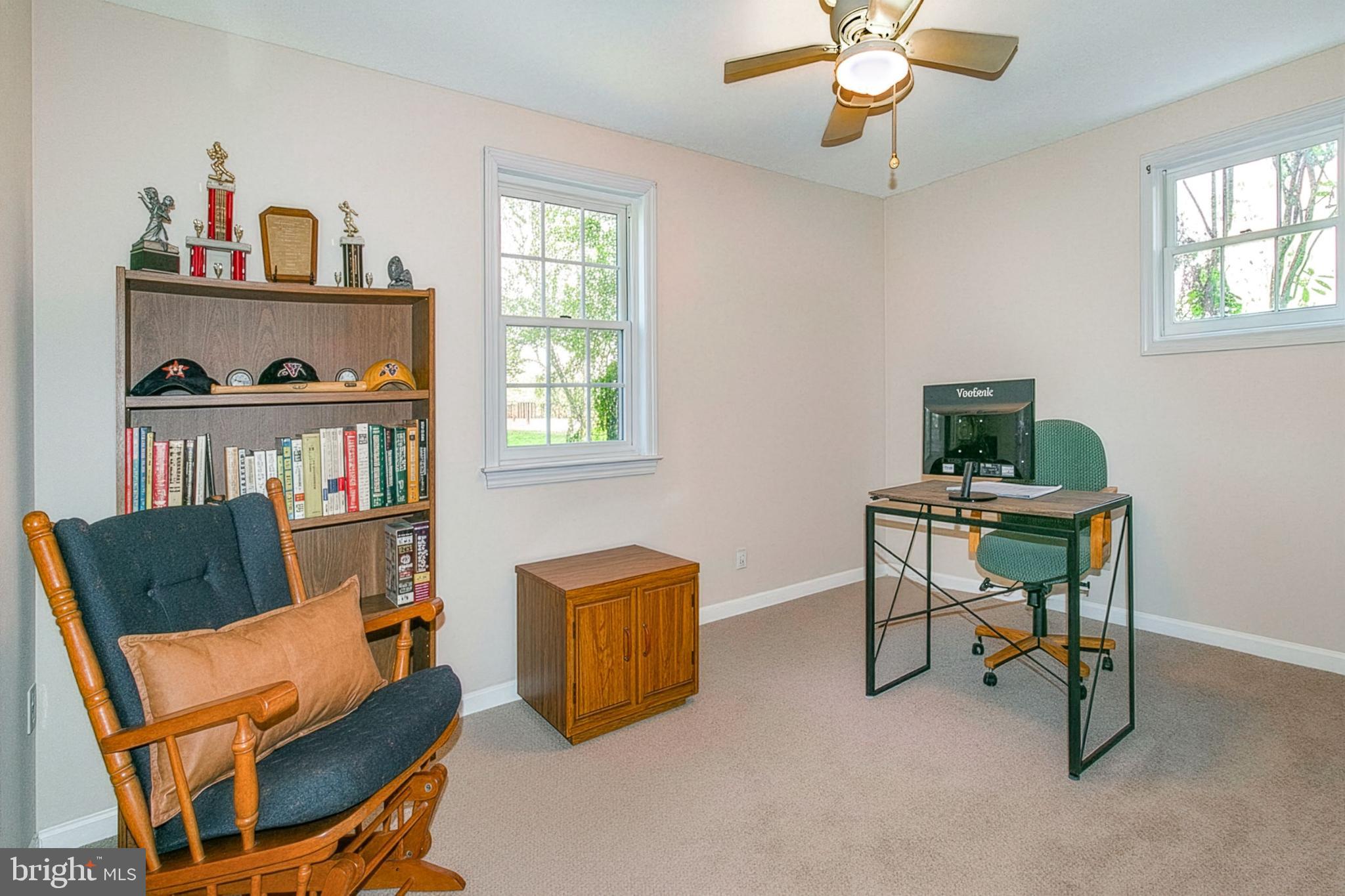 12415 Caisson Road Fairfax, VA 22030 - Photo 29 of 39 a living room with furniture and a book shelf