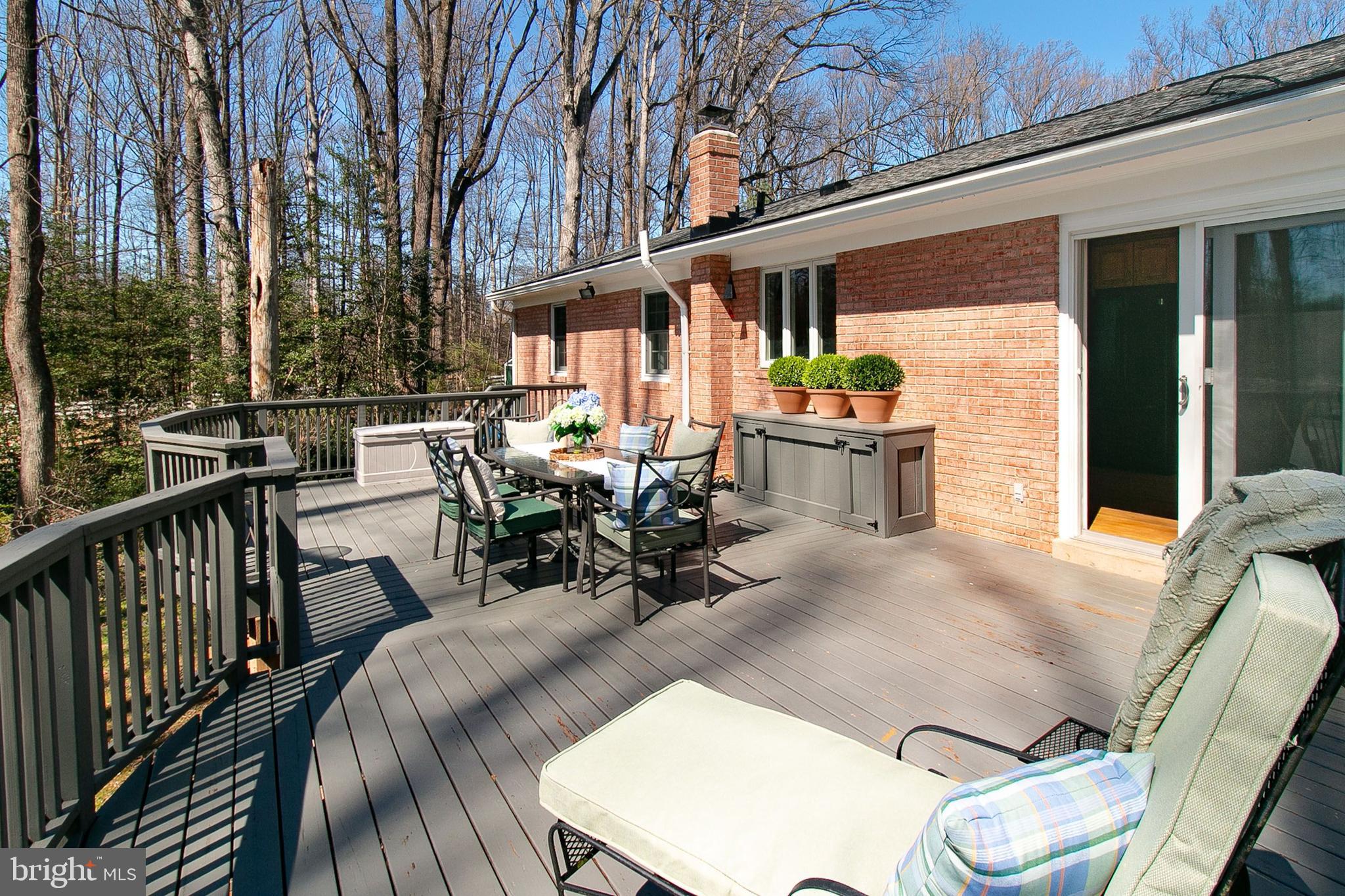 12415 Caisson Road Fairfax, VA 22030 - Photo 4 of 39 a view of a patio with table and chairs potted plants with wooden floor and fence