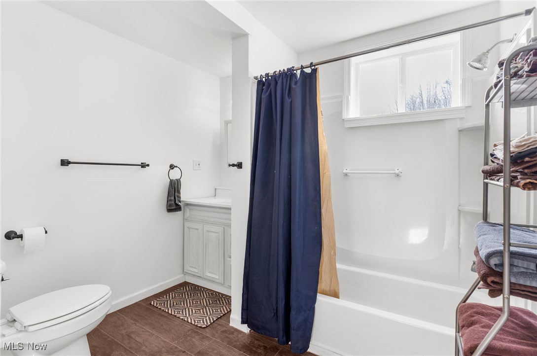 6590 Hall Road Andover, OH 44003 - Photo 5 of 29 Full bath featuring vanity, wood tiled floors, and shower / bath combo with shower curtain