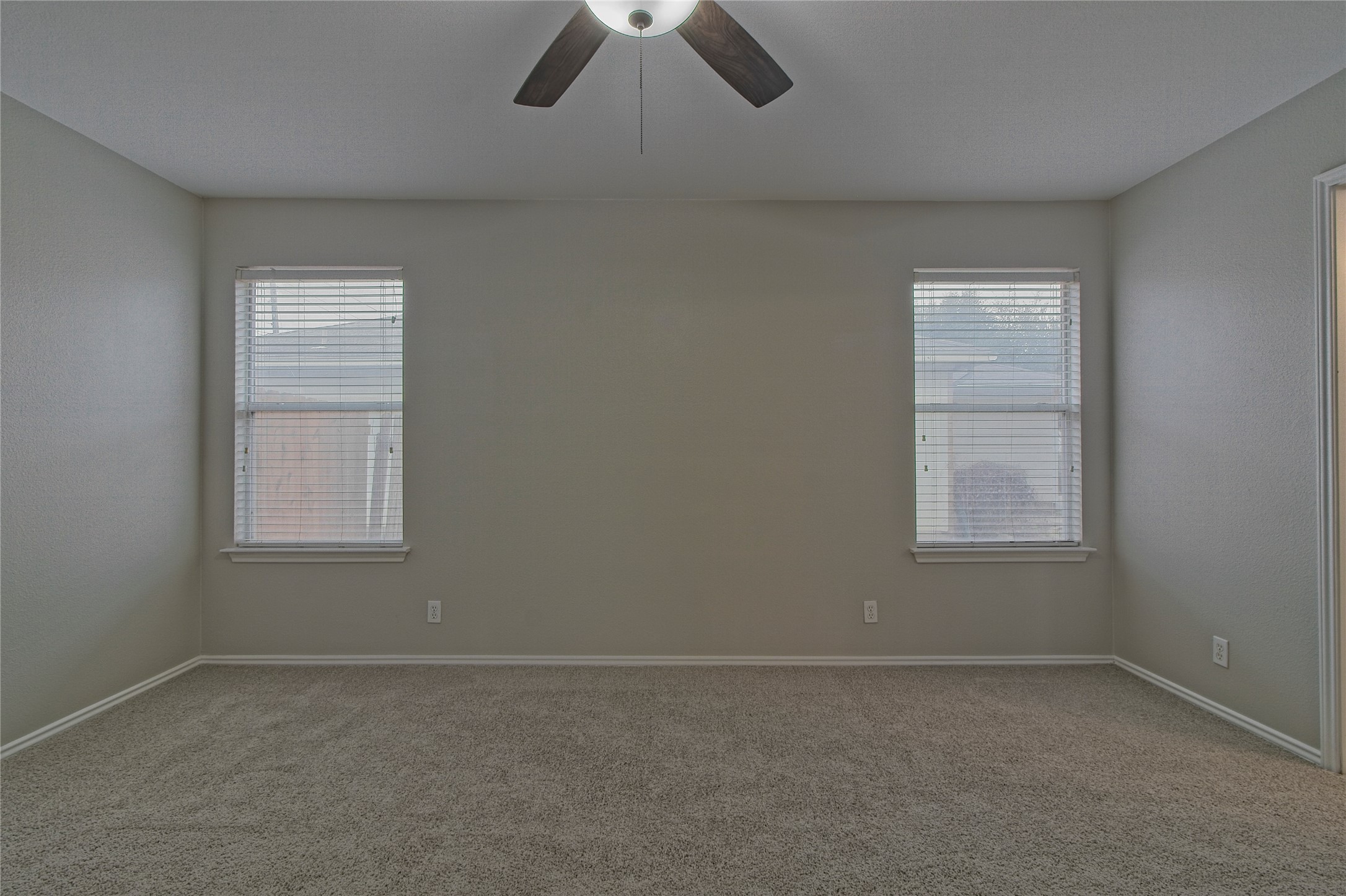 232 Brickyard Lane Jarrell, TX 76537 - Photo 17 of 31 A well-lit bedroom featuring ample wall space and comfortable carpeting.