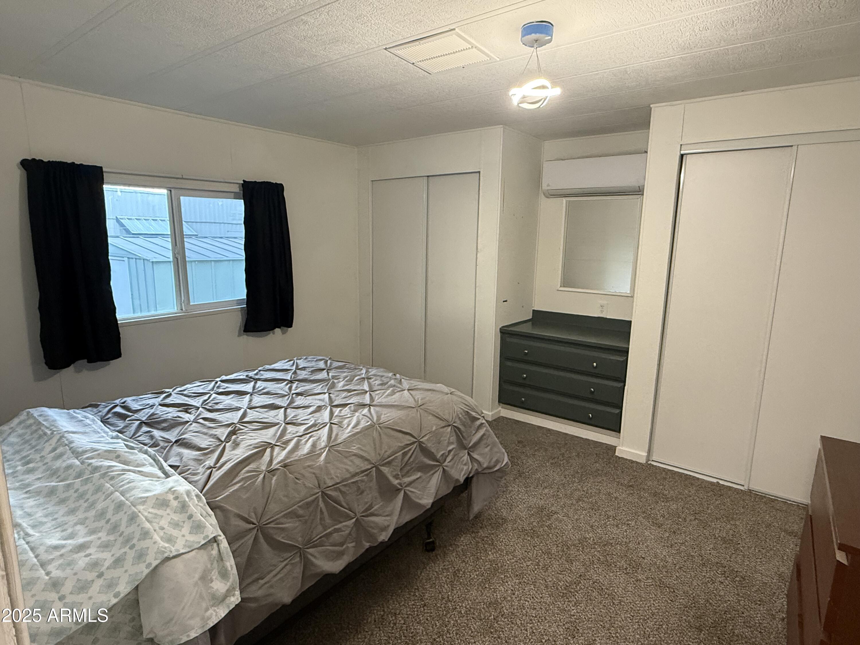 16005 North 32nd Street, Unit 66 Phoenix, AZ 85032 - Photo 6 of 7 a bedroom with a bed and a window