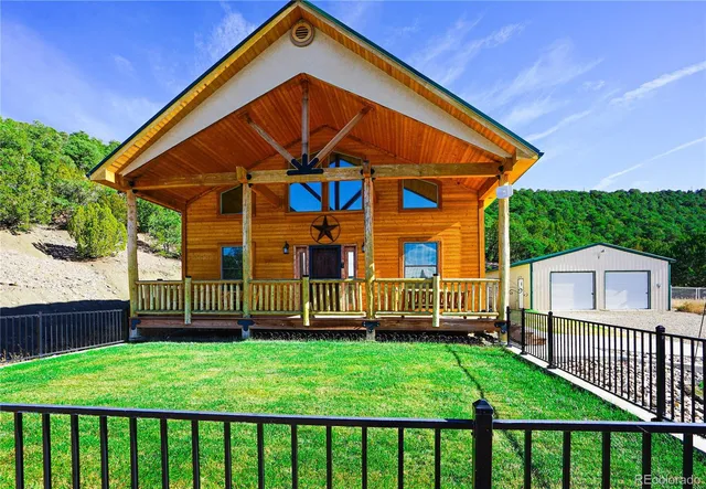 a view of a small house with a yard