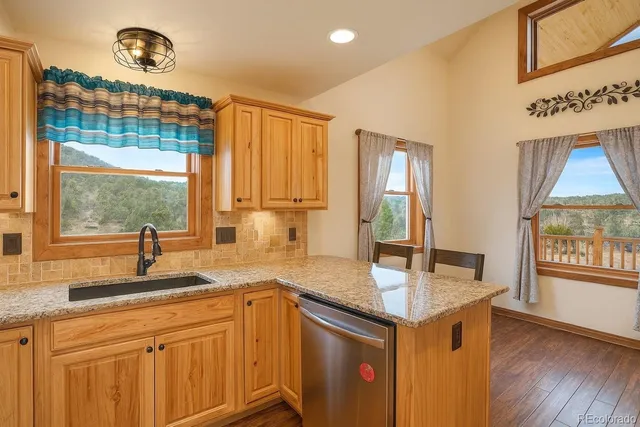 a kitchen with granite countertop a sink and a window