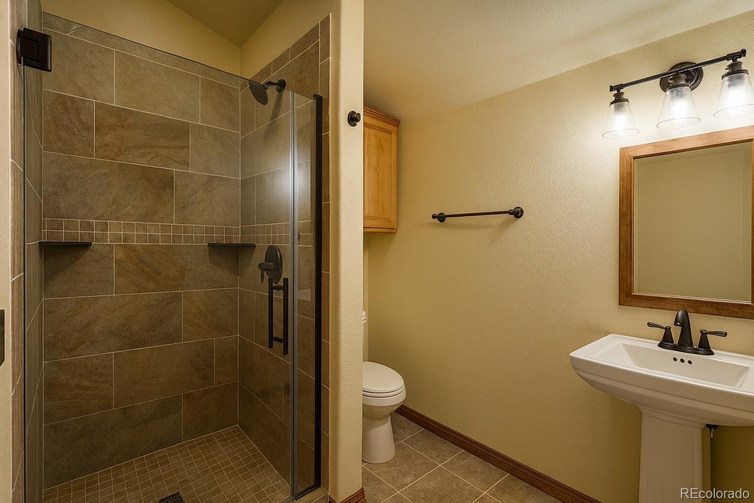 11799 County Road Trinidad, CO 81082 - Photo 19 of 45 a bathroom with a granite countertop sink toilet and shower