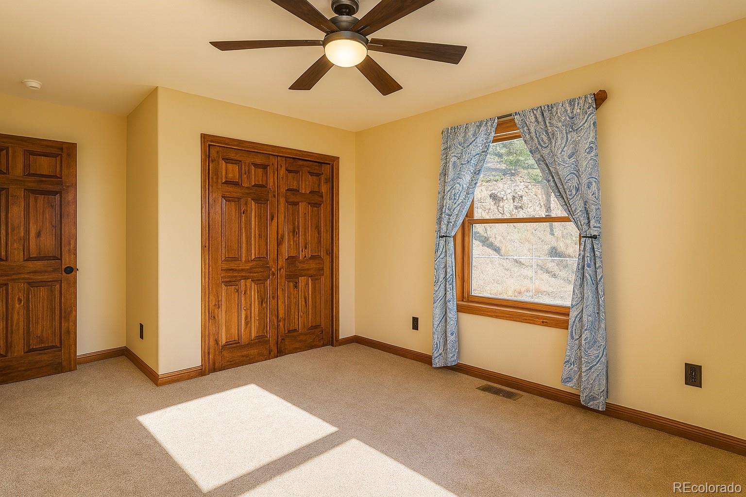 11799 County Road Trinidad, CO 81082 - Photo 20 of 45 an empty room with windows and fan