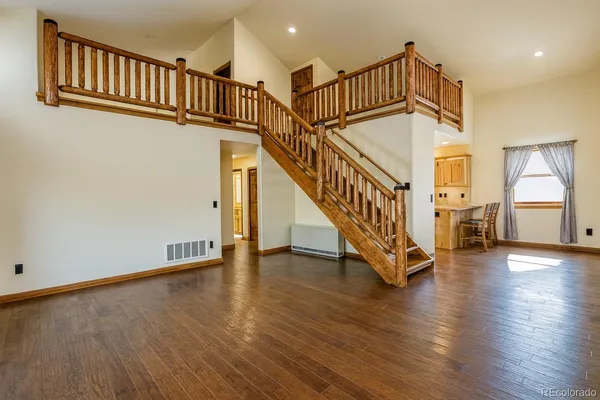 a view of staircase with white walls and a window