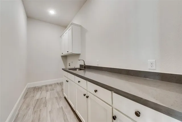 a kitchen with granite countertop white cabinets and white appliances