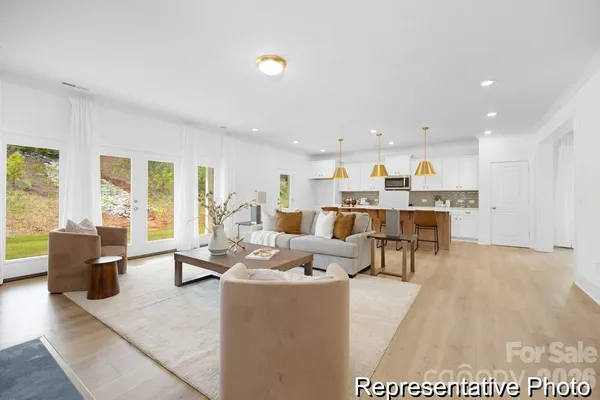 a living room with lots of furniture and kitchen view