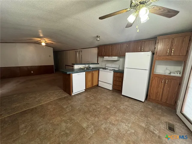 a kitchen with sink cabinets and refrigerator