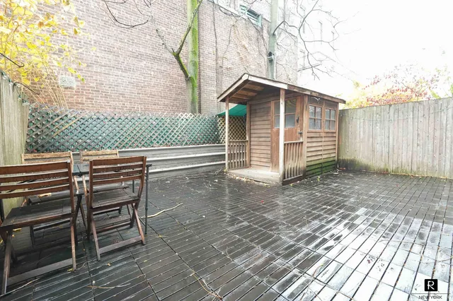 a view of a roof deck with wooden floor and fence