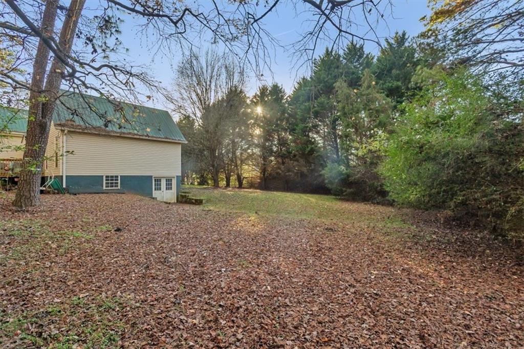 16049 Hopewell Road Alpharetta, GA 30004 - Photo 23 of 30 a view of a house with a yard and garage