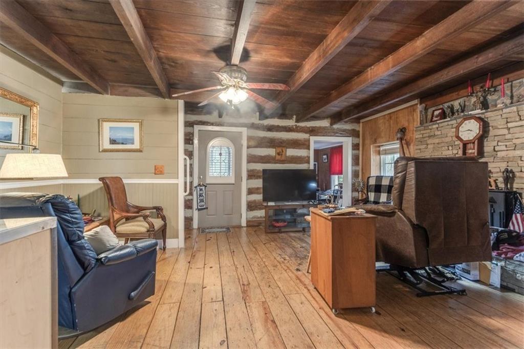 16049 Hopewell Road Alpharetta, GA 30004 - Photo 9 of 30 a living room with furniture a flat screen tv and kitchen view