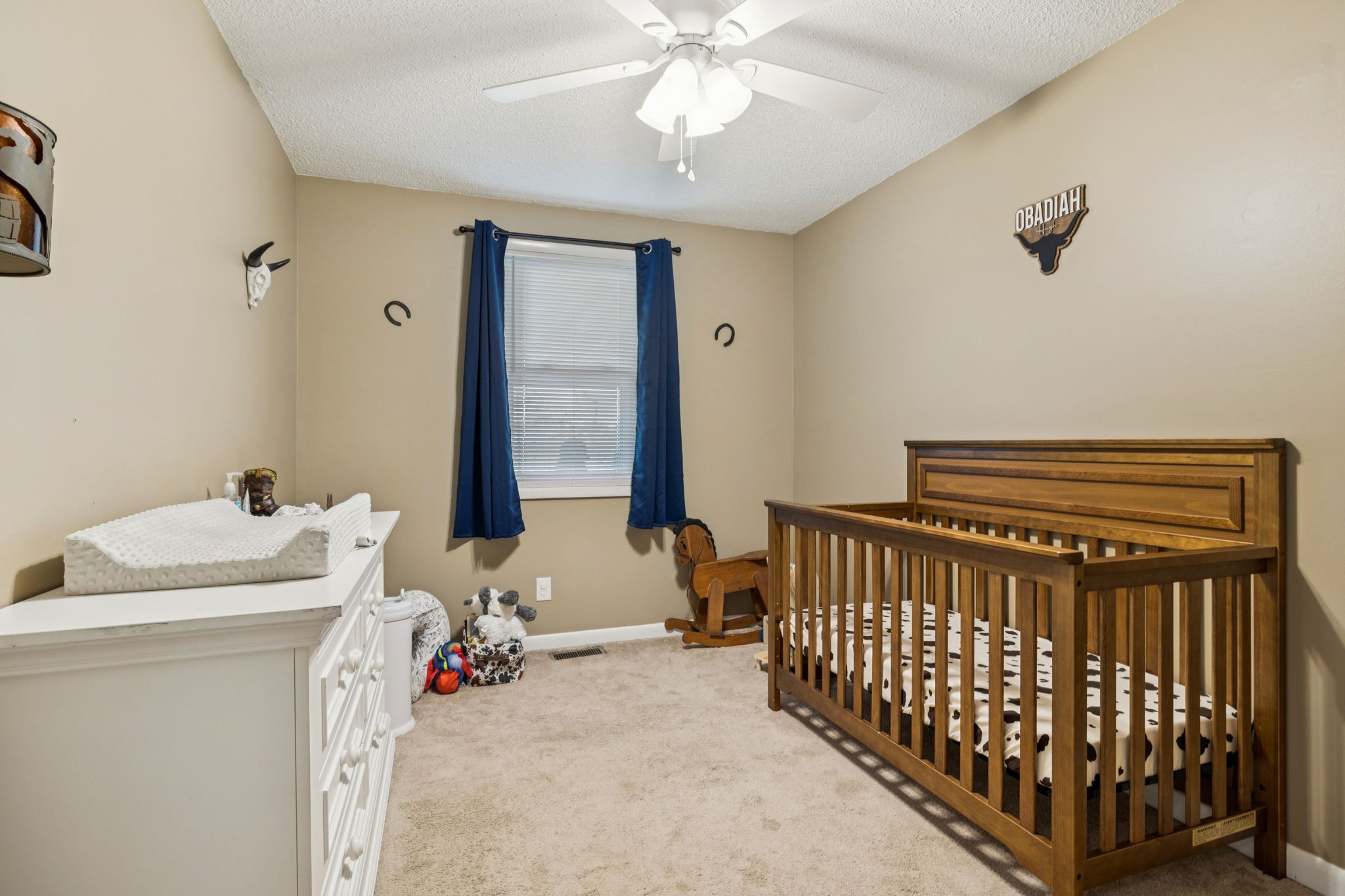 699 Rock Bridge Road Gallatin, TN 37066 - Photo 12 of 35 a bedroom with a bed and a chandelier