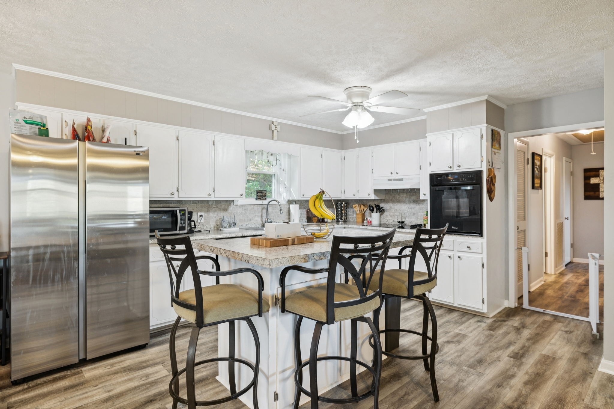 699 Rock Bridge Road Gallatin, TN 37066 - Photo 4 of 35 a kitchen with stainless steel appliances a table chairs refrigerator and microwave