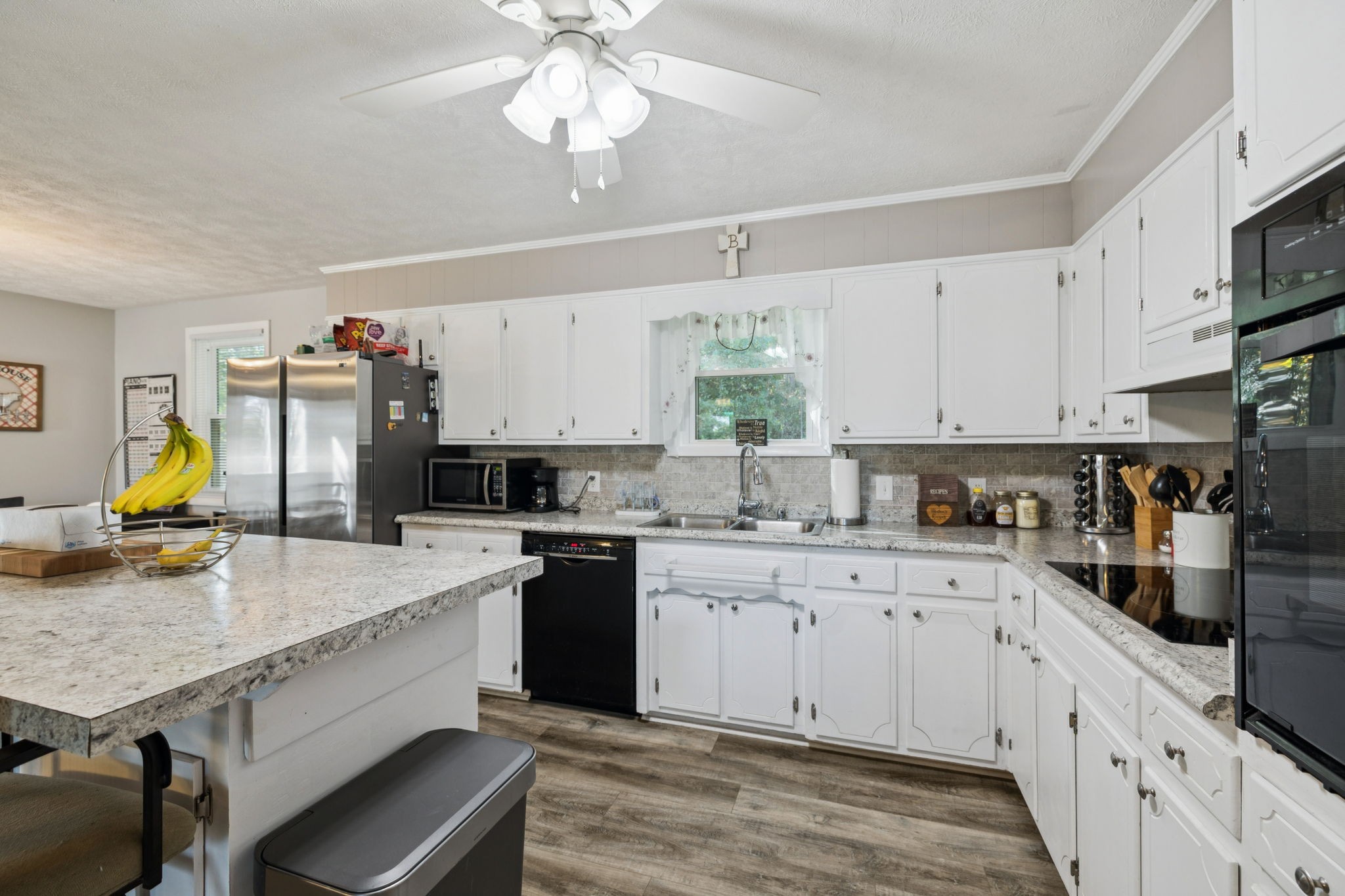 699 Rock Bridge Road Gallatin, TN 37066 - Photo 5 of 35 a kitchen with stainless steel appliances granite countertop a sink dishwasher stove and white cabinets