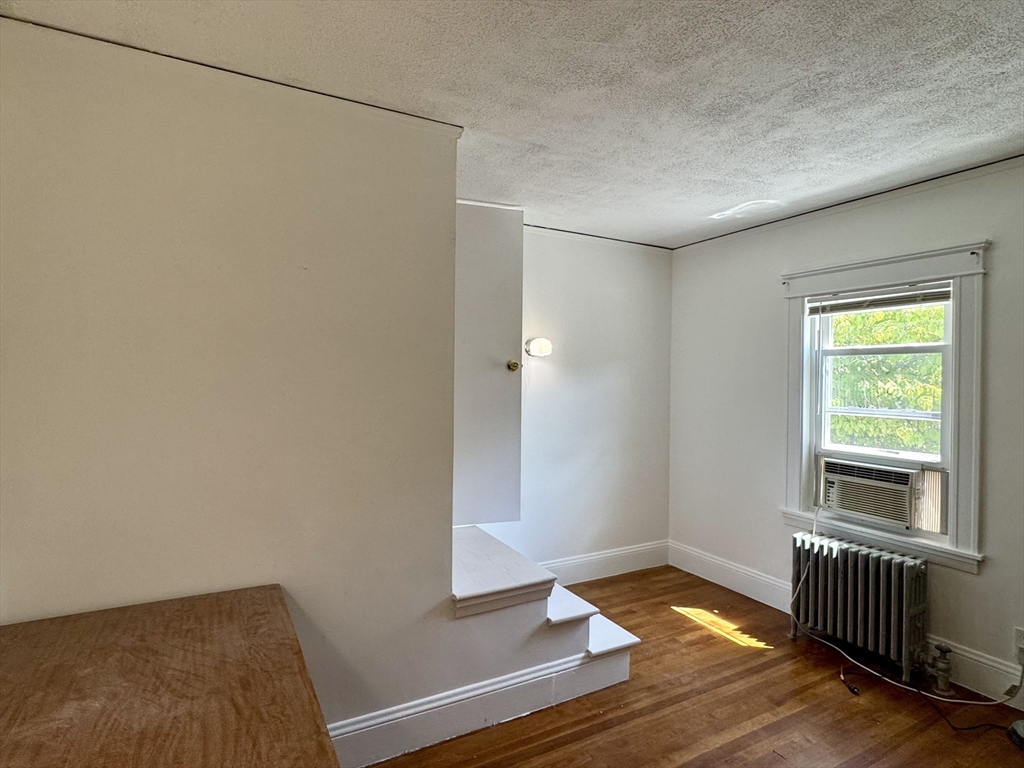 1639 Washington Street Newton, MA 02465 - Photo 14 of 20 a view of empty room with wooden floor and fan