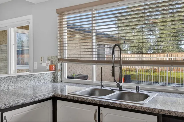 a kitchen sink sitting next to a window