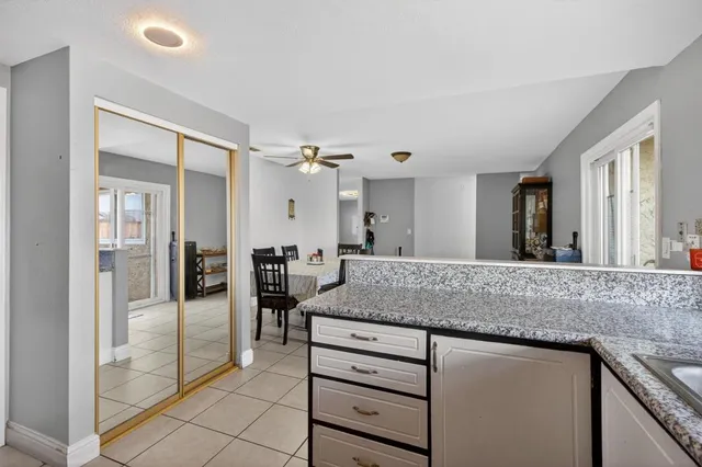 a kitchen with granite countertop a sink and cabinets