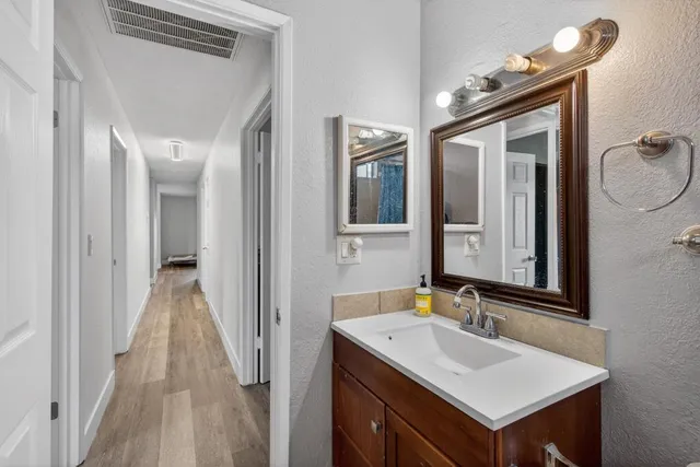 a en suite bathroom with a sink mirror and shower