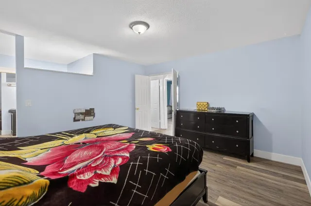 a bedroom with a bed and a mirror