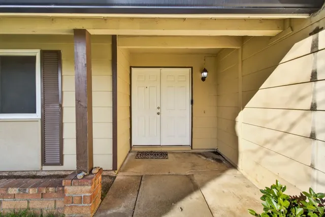 a view of a door with a small yard
