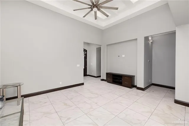 an empty room with fireplace and fan