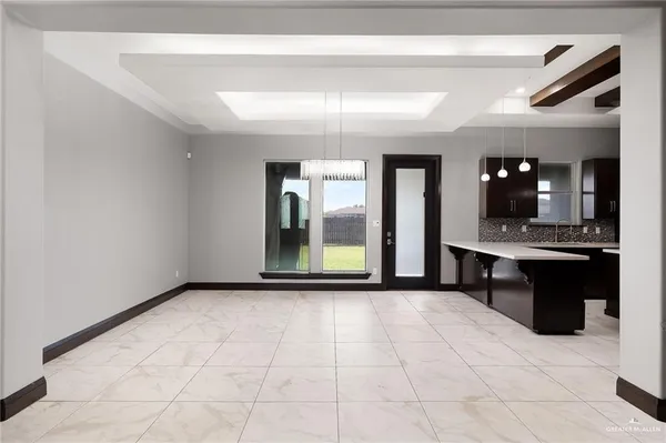 a large kitchen with a sink and refrigerator