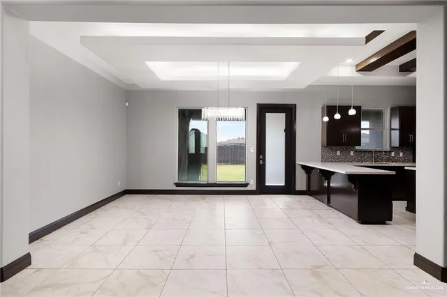 a large kitchen with a sink and refrigerator