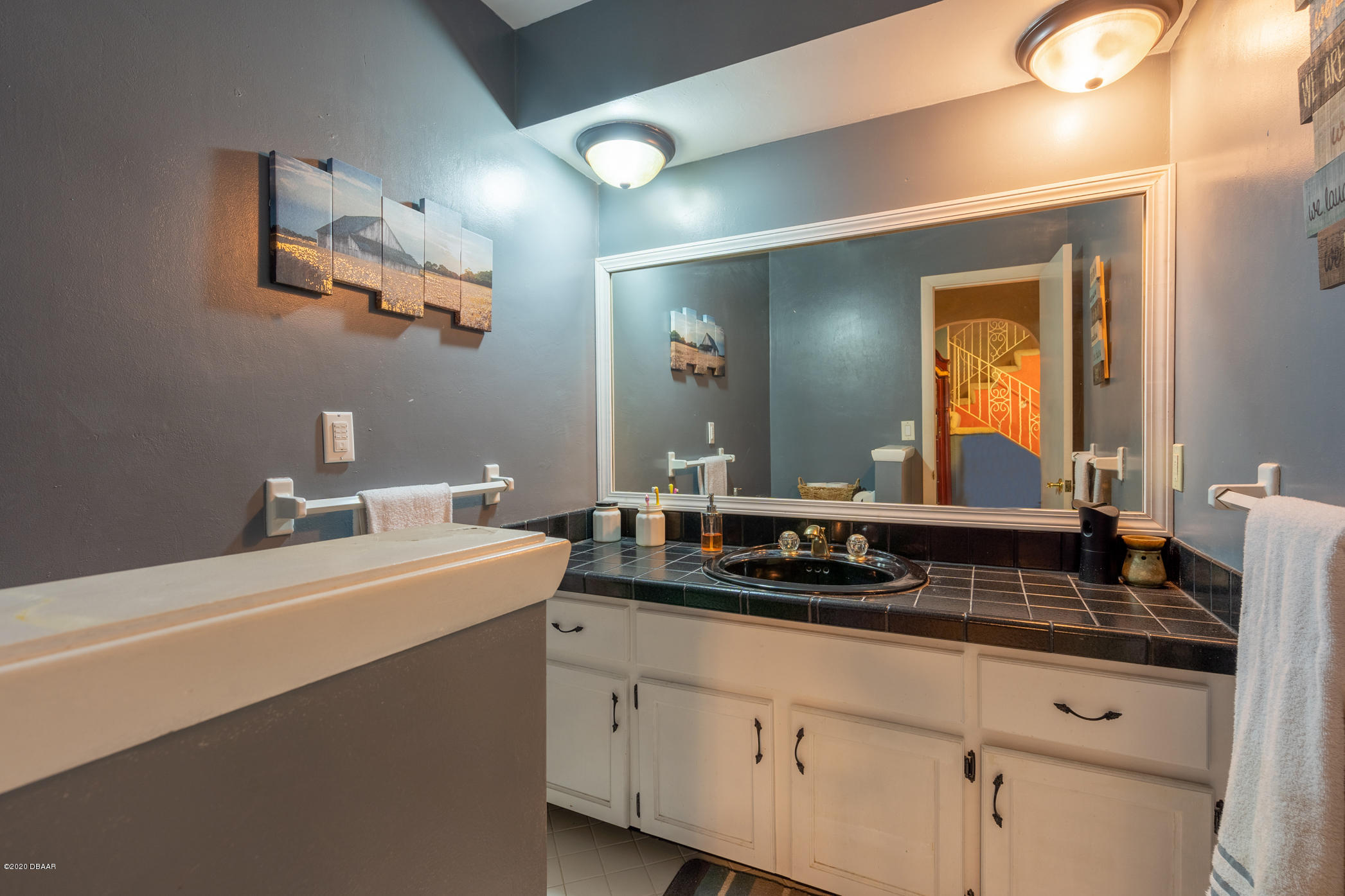 7 Twin River Drive Ormond Beach, FL 32174 - Photo 11 of 45 a bathroom with a sink and a mirror