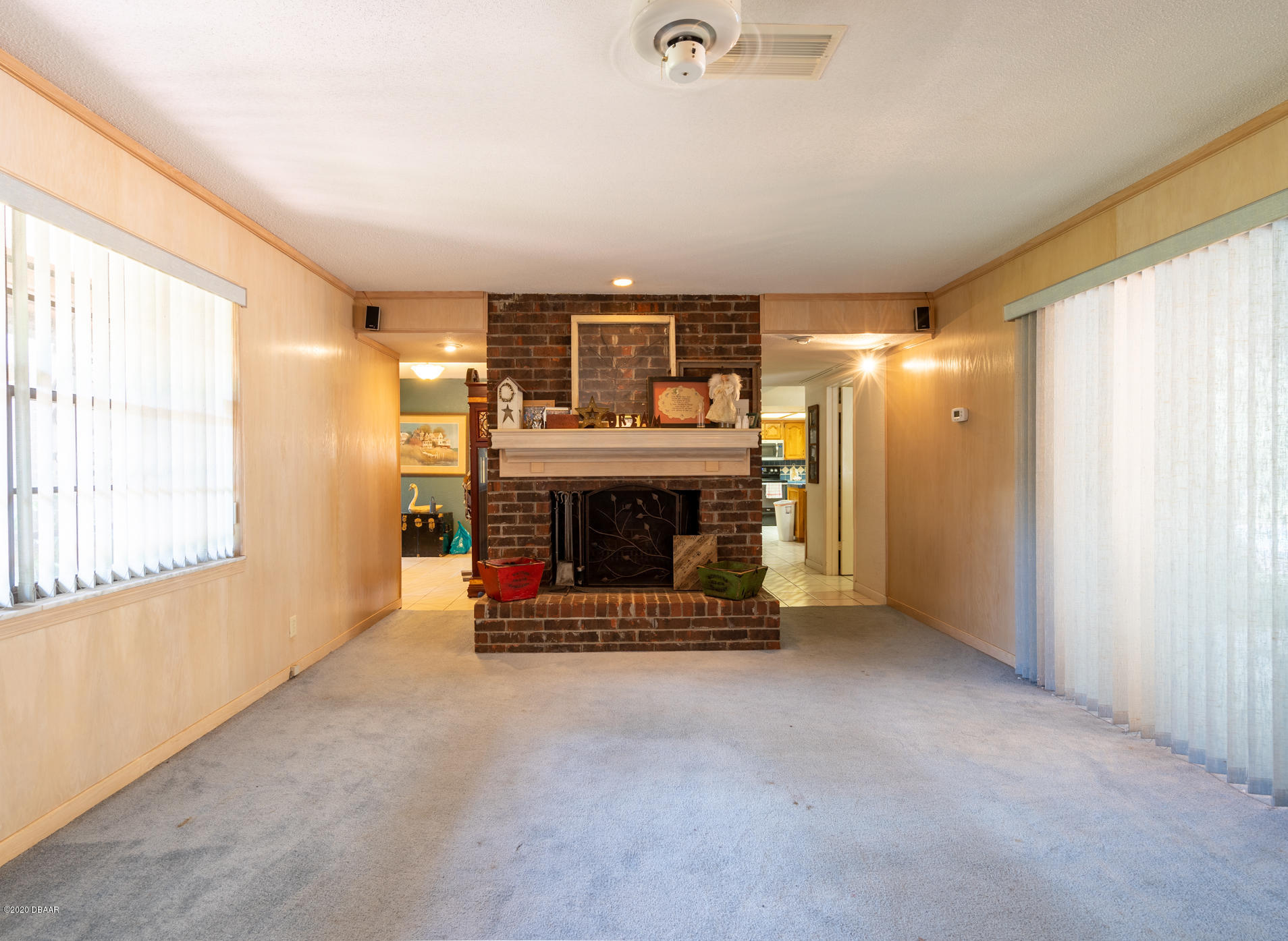 7 Twin River Drive Ormond Beach, FL 32174 - Photo 19 of 45 a view of an empty room with a fireplace and a window