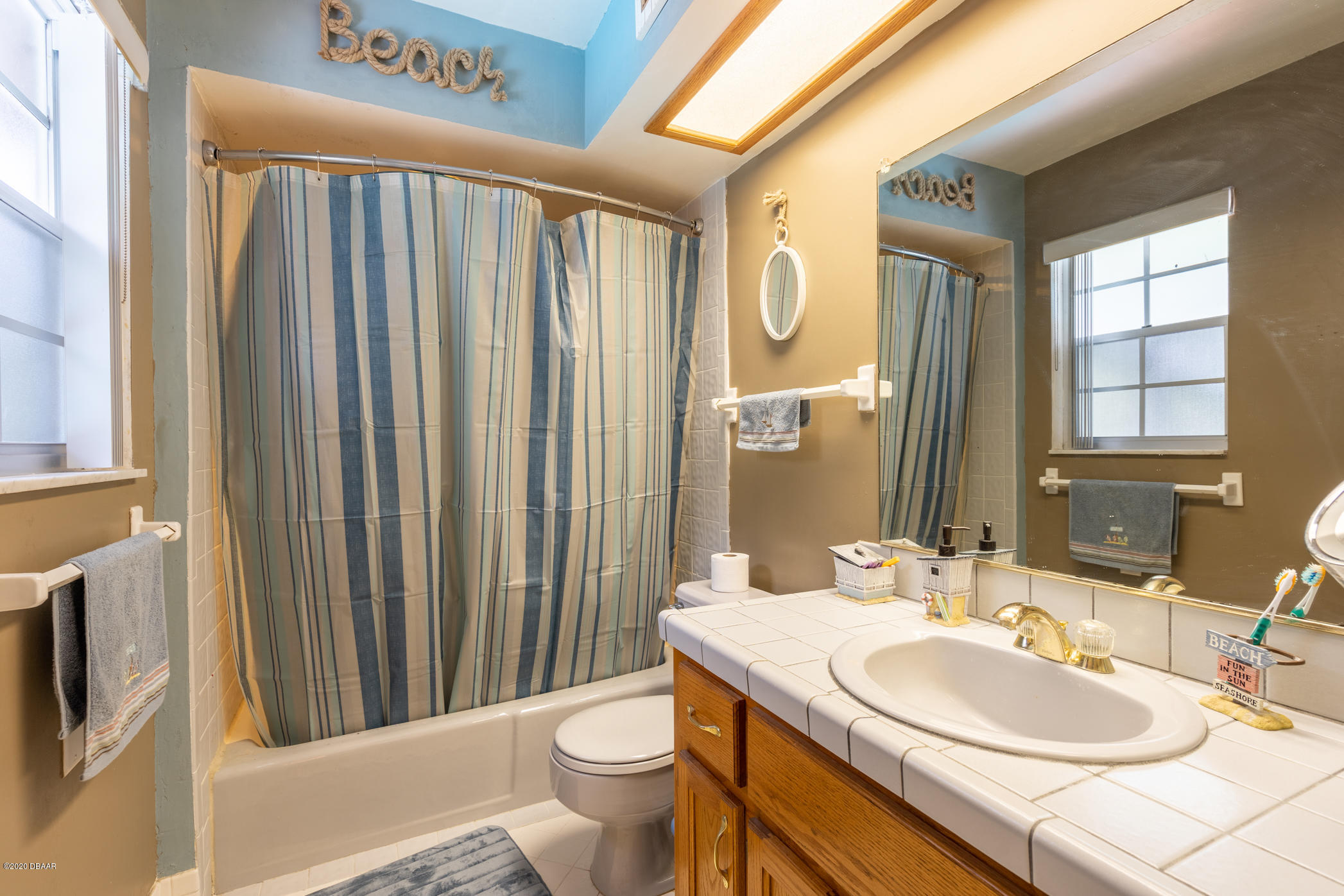 7 Twin River Drive Ormond Beach, FL 32174 - Photo 23 of 45 a bathroom with a sink a toilet a mirror and shower