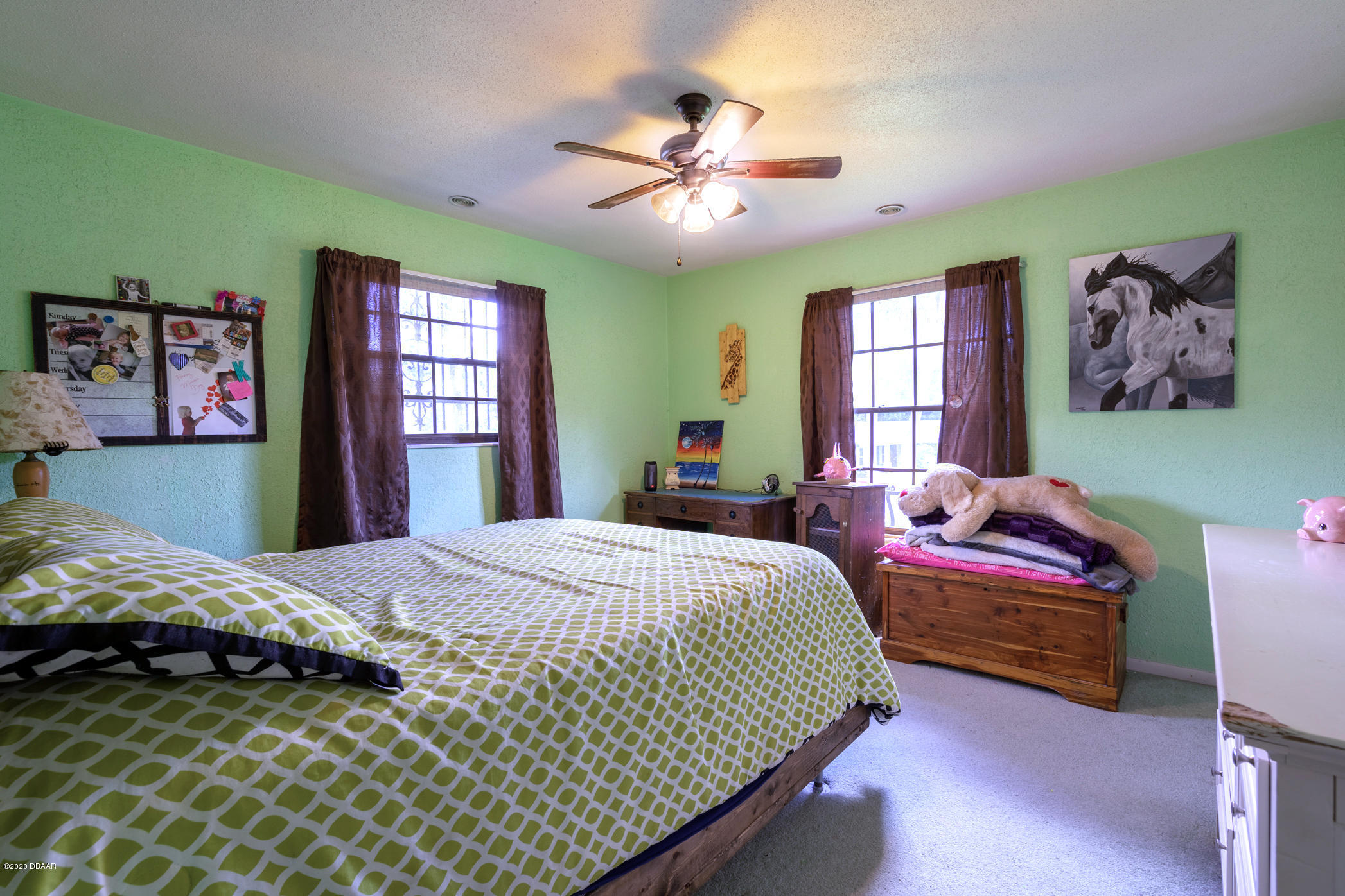 7 Twin River Drive Ormond Beach, FL 32174 - Photo 24 of 45 a bedroom with a bed and a chandelier