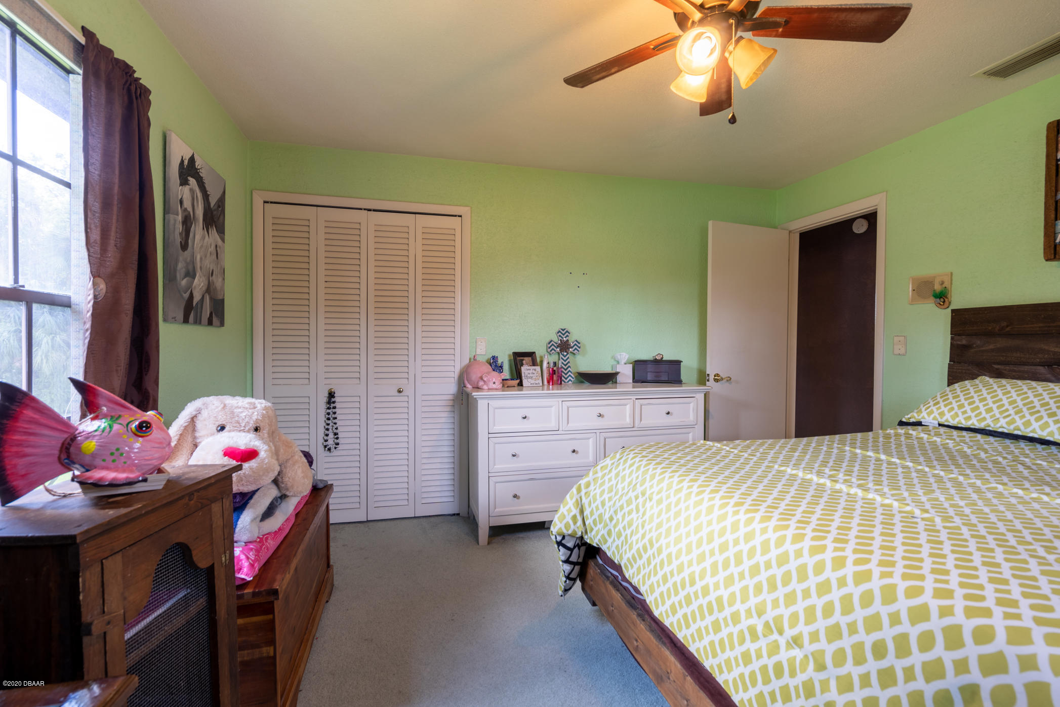 7 Twin River Drive Ormond Beach, FL 32174 - Photo 25 of 45 a bedroom with a bed and a chandelier