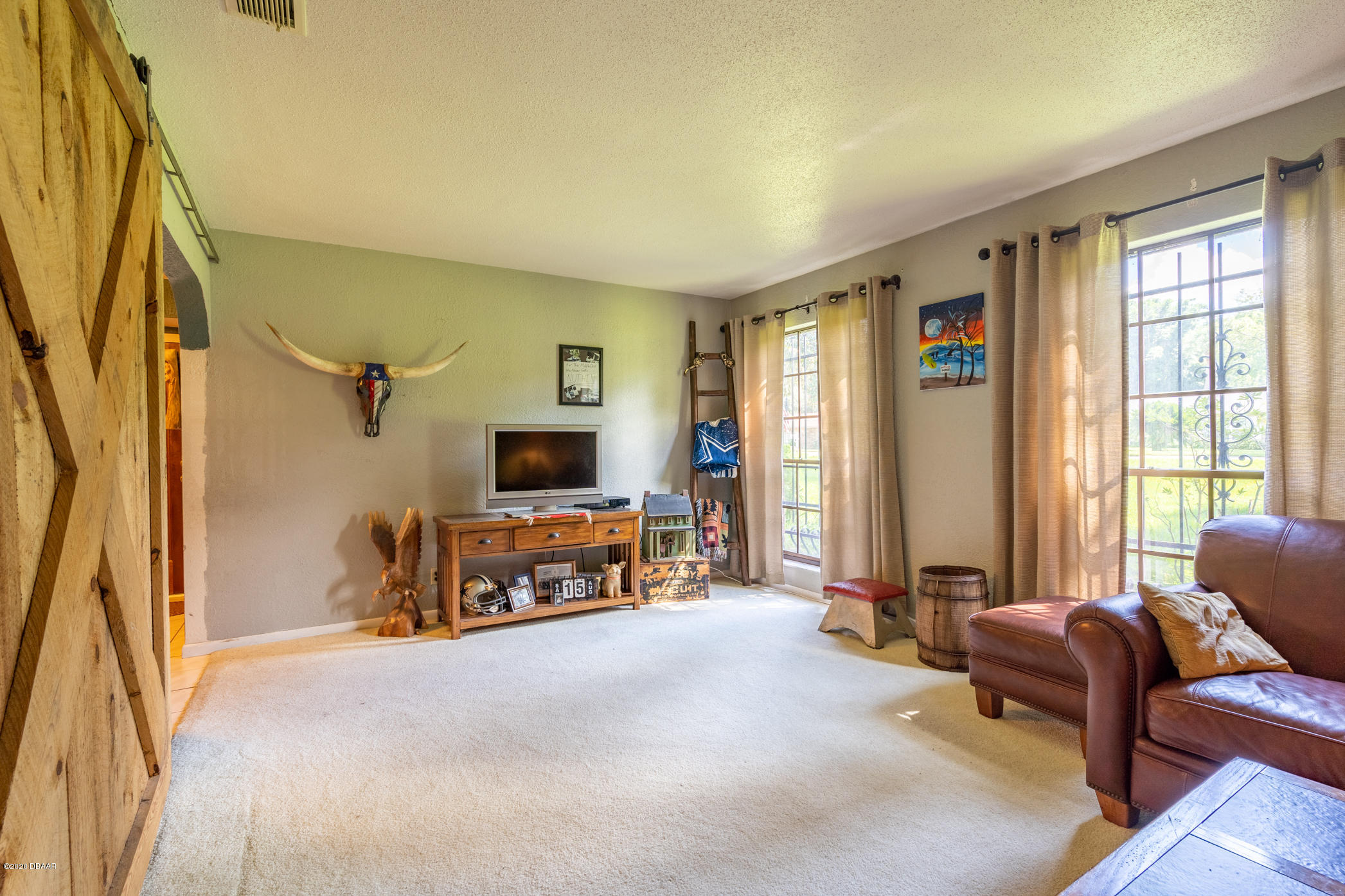 7 Twin River Drive Ormond Beach, FL 32174 - Photo 8 of 45 a living room with furniture and a flat screen tv